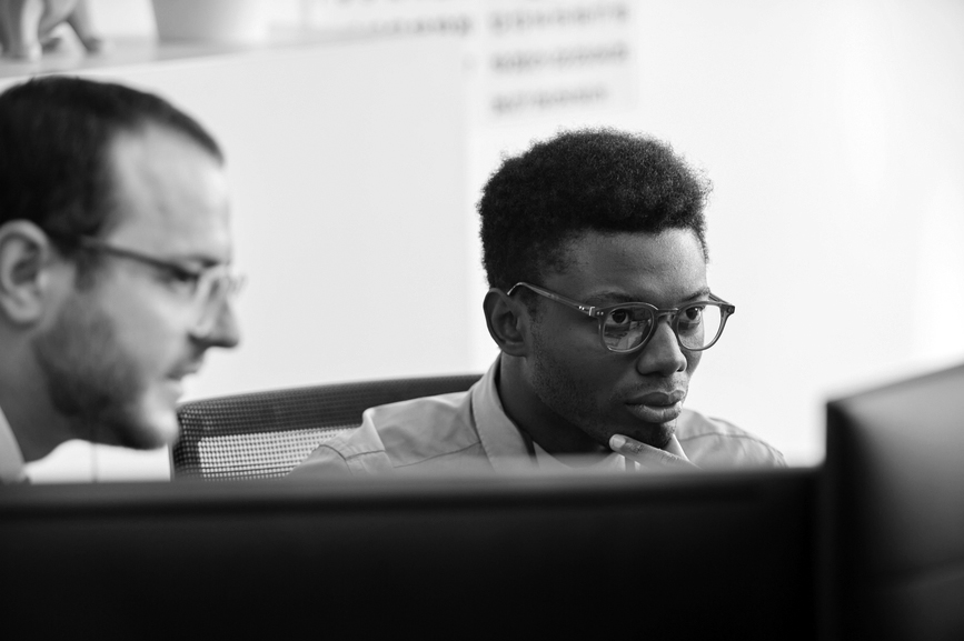 young men staring at a monitor